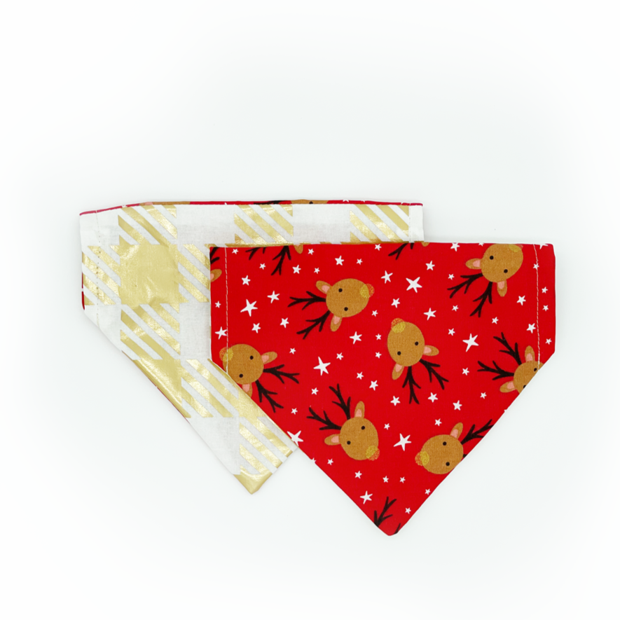 Christmas Gift dog bandana on white background with shiny gold one one side and red with reindeer on the other