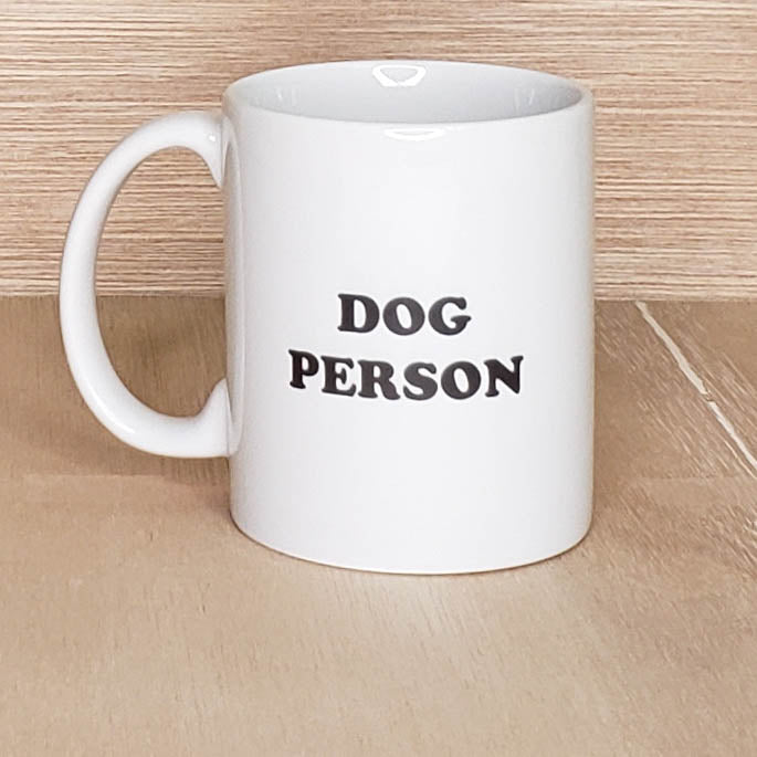 A white coffee mug with black text that reads Dog Person in bold black letters