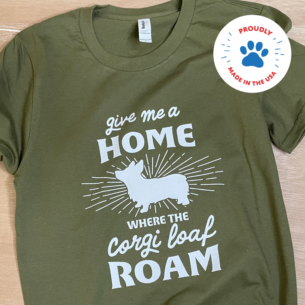 Pine green shirt. White design says Give me a Home where the Corgi loaf roam. Features a Pembroke welsh corgi graphic. Made in the USA.