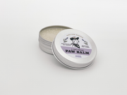 tin of dog paw balm reads calming lavender paw balm, made in Texas by Vaya Con Doggos