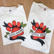 White t-shirts for Dog Mom and Dog Dad as a coulple, with tattoo style dog paw graphic 