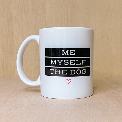 Me Myself and the Dog Mug. Design is black and white with a red heart. Photographed on wood background.